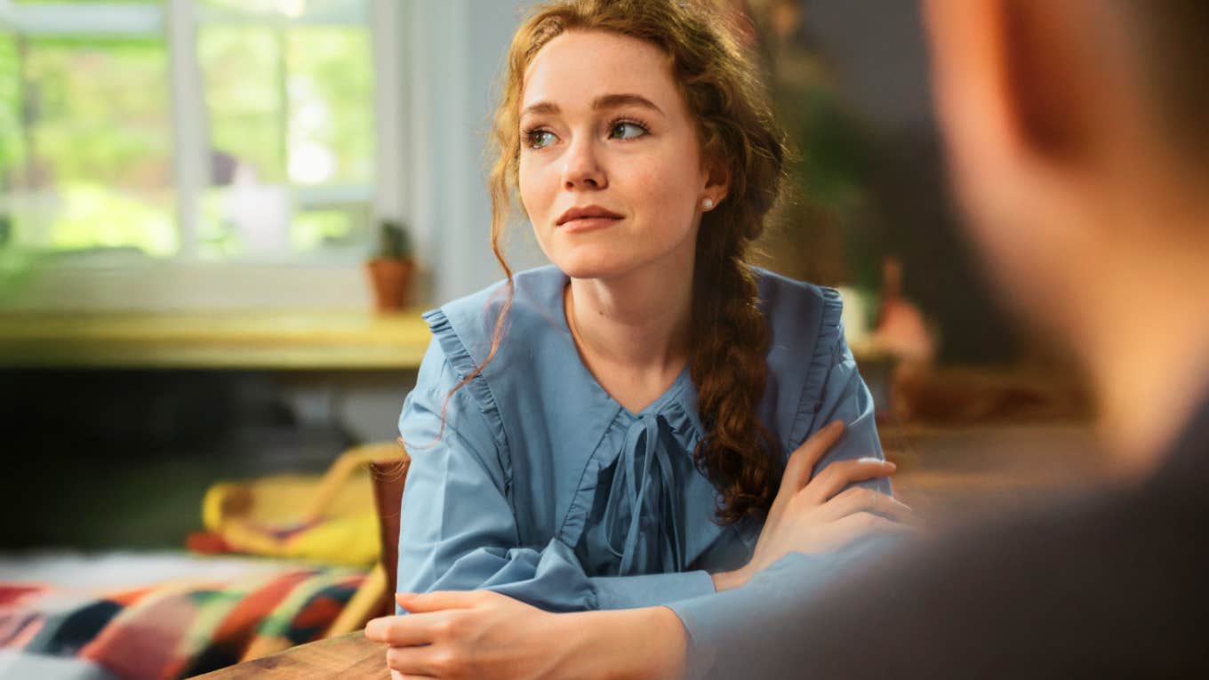 Contemptuous woman sitting across from partner