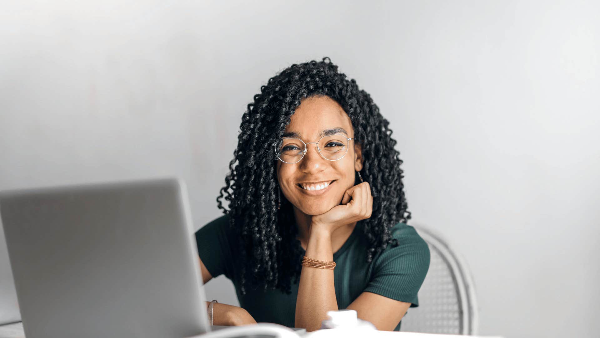 woman smiling while on laptop