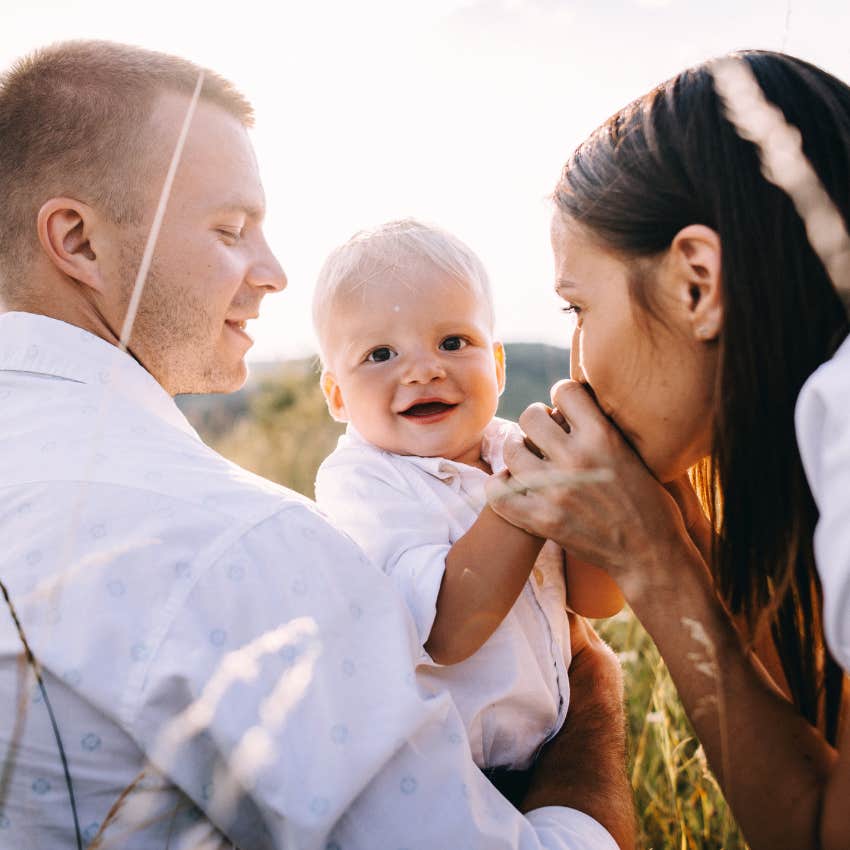 Young beautiful family with a young son walking sunny summer day