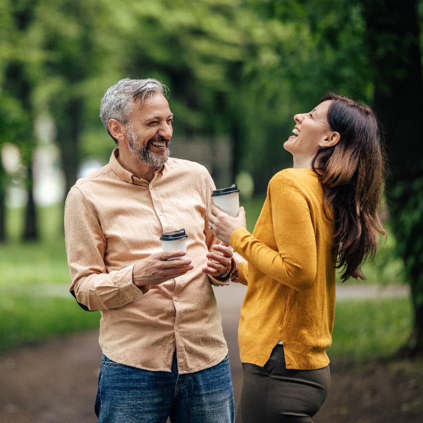 Unofficially dating couple laughing at an inside joke