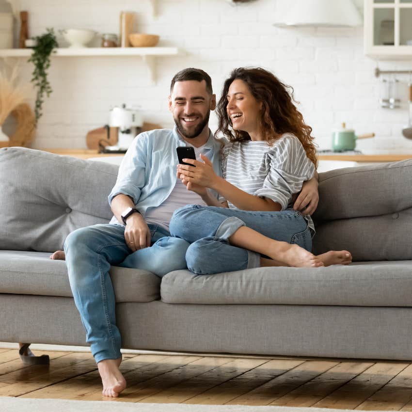 Couple laughing at memes on a phone