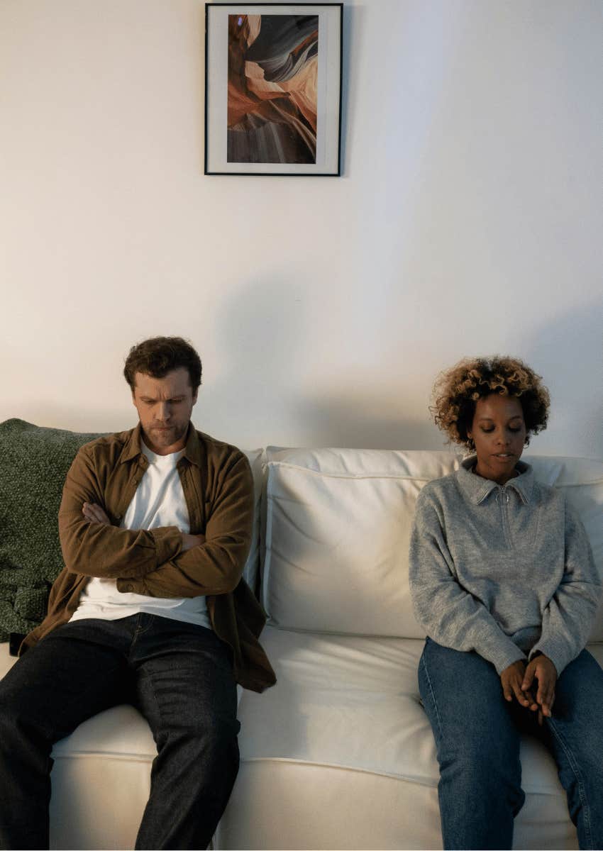 couple sitting away from each other on sofa