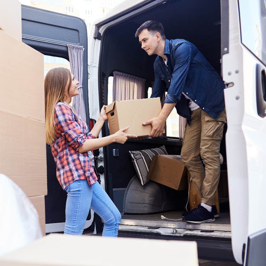 Couple unloading moving truck at their new home