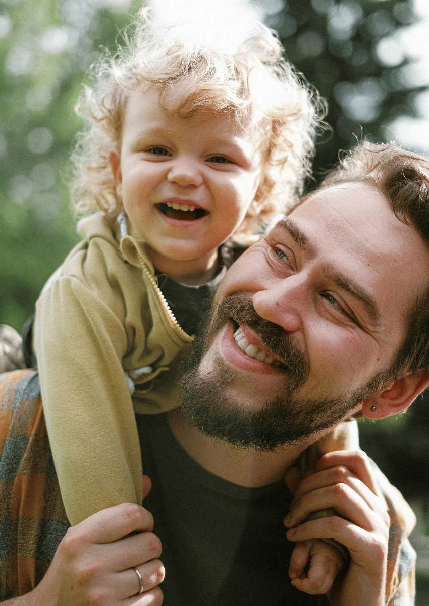 dad giving a young boy a piggy back ride