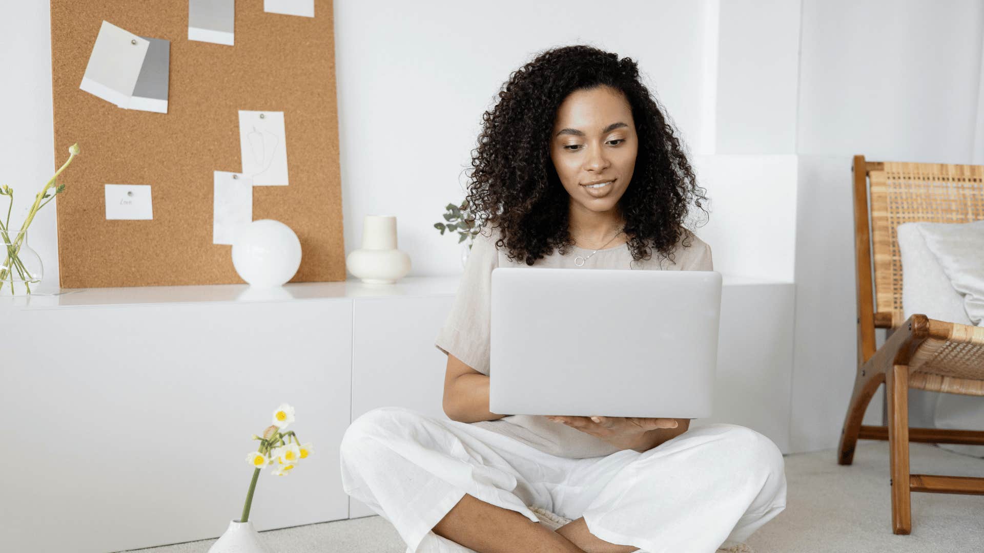 woman smiling while on a laptop