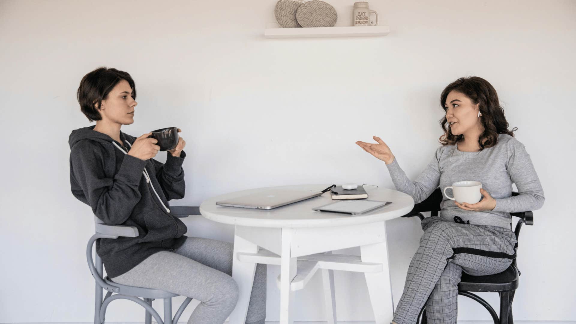 women talking to each other while having coffee