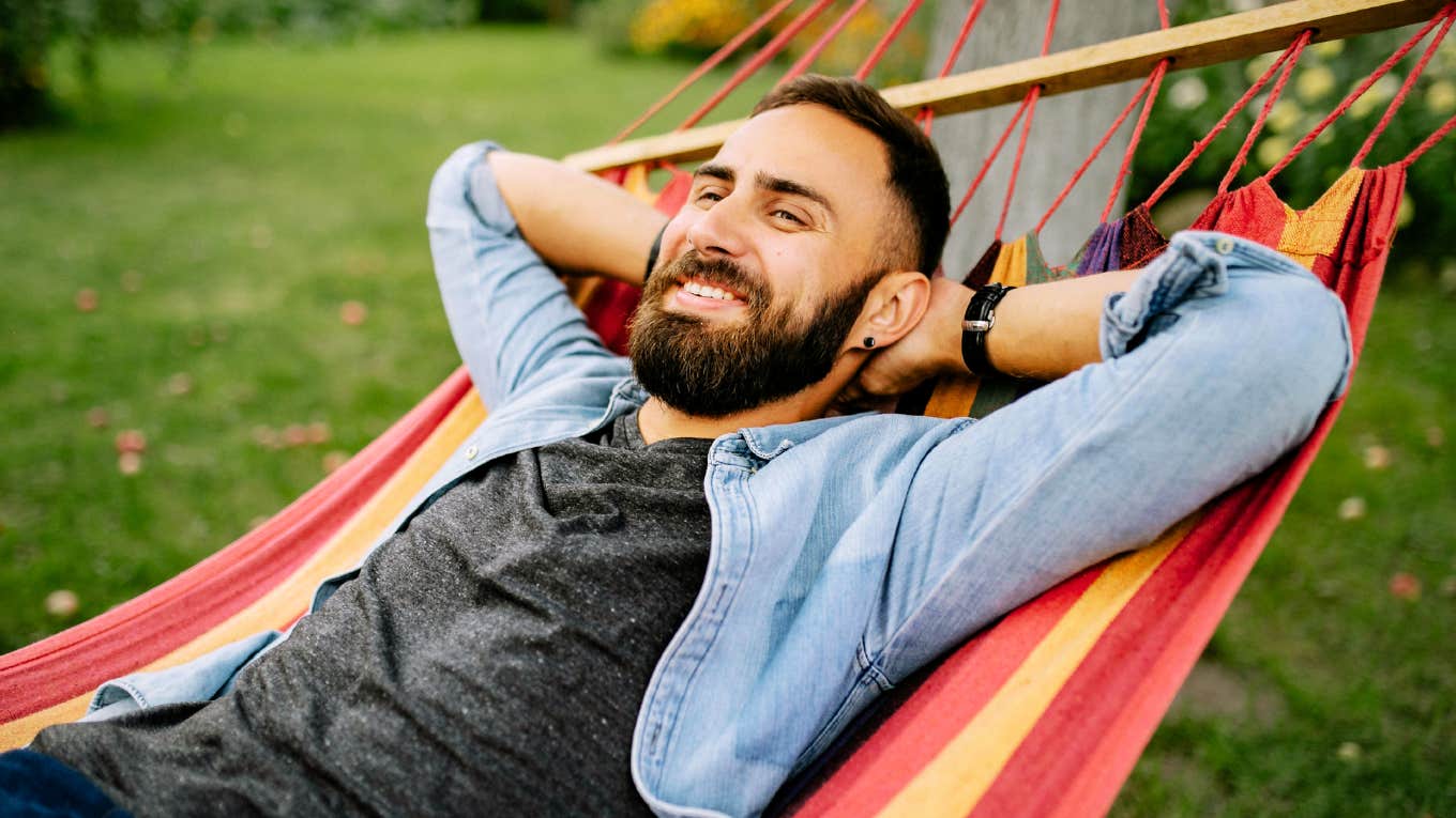 Man with high IQ, lounging in hammock. 