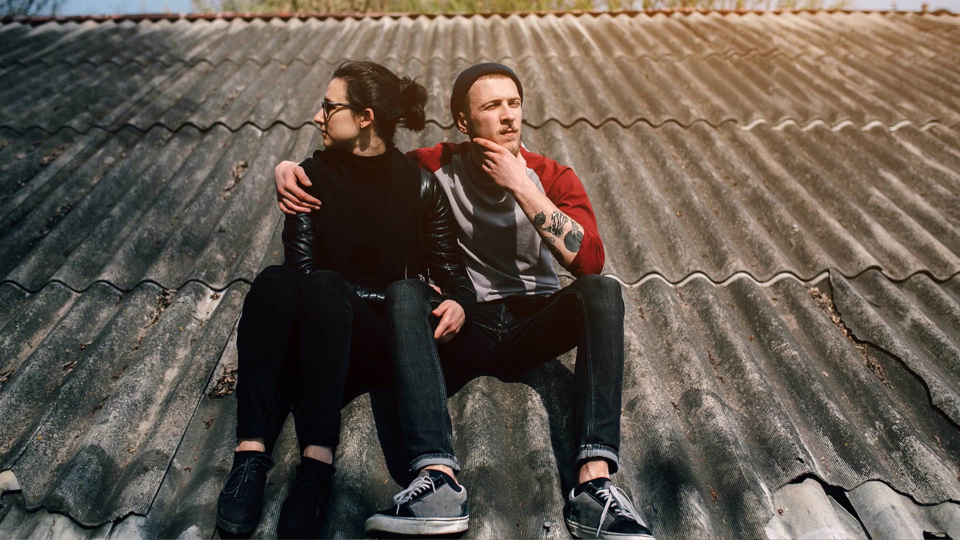 young beautiful couple on the house roof