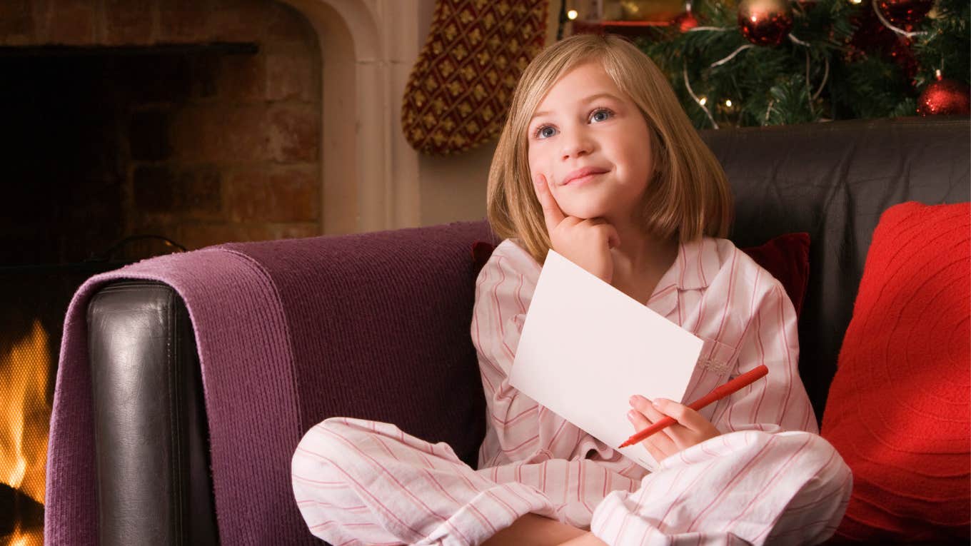 Girl writing Christmas wish list