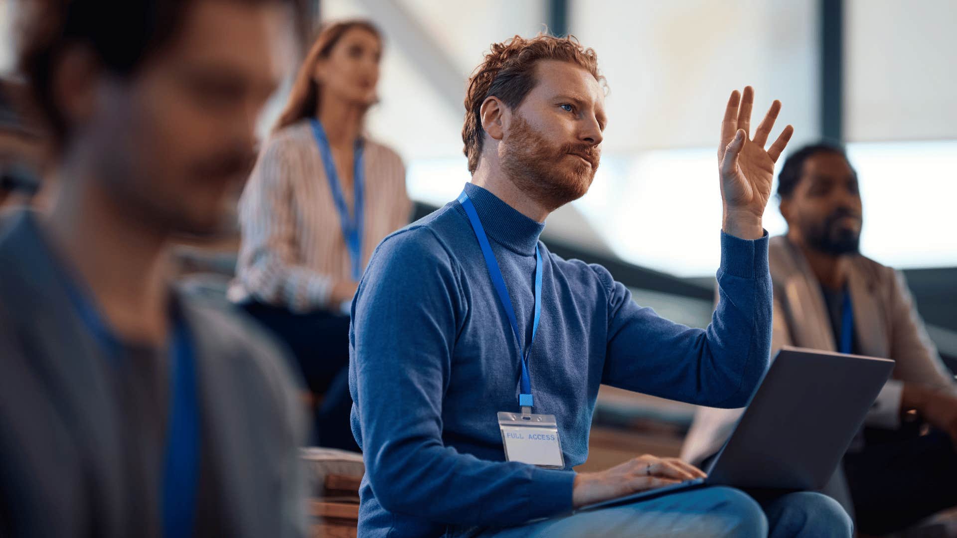 man raising hand