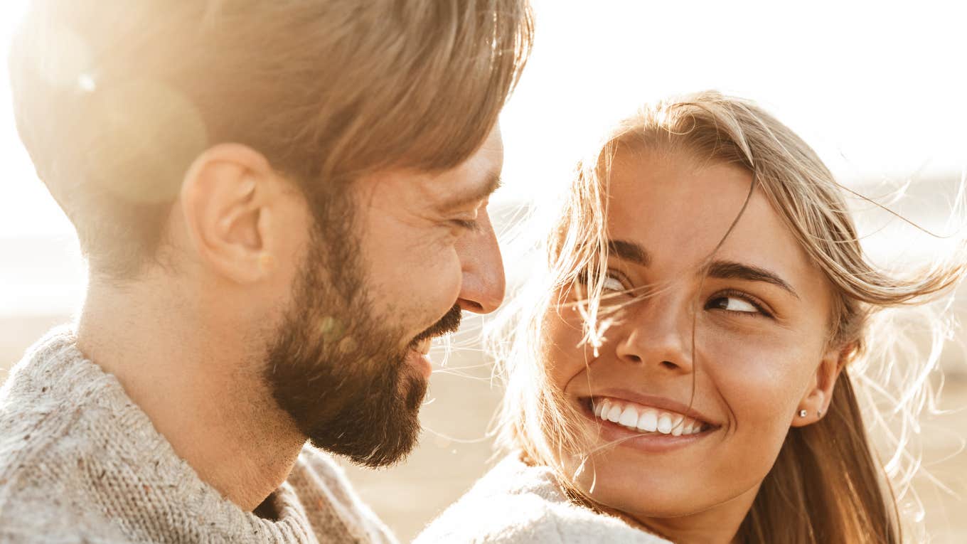 Happy couple in love smiling at each other