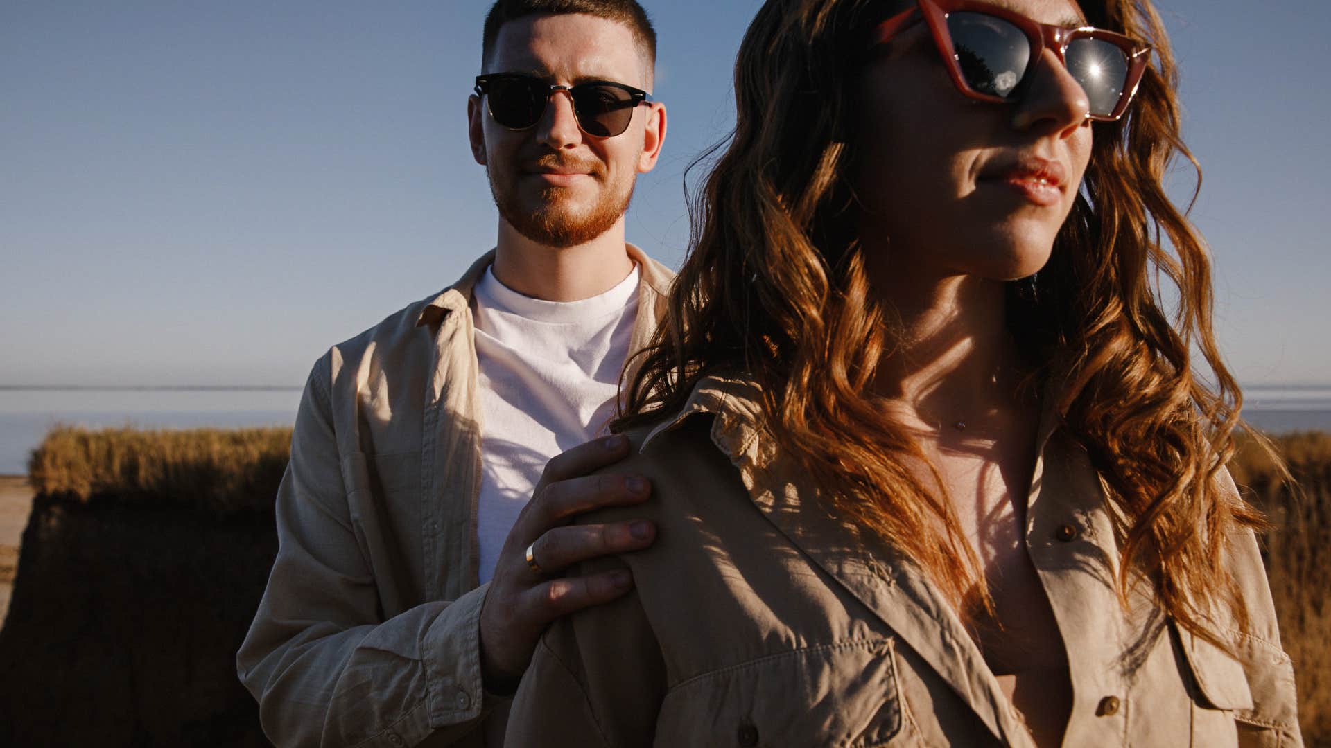 couple with sunglasses on walking together outdoors