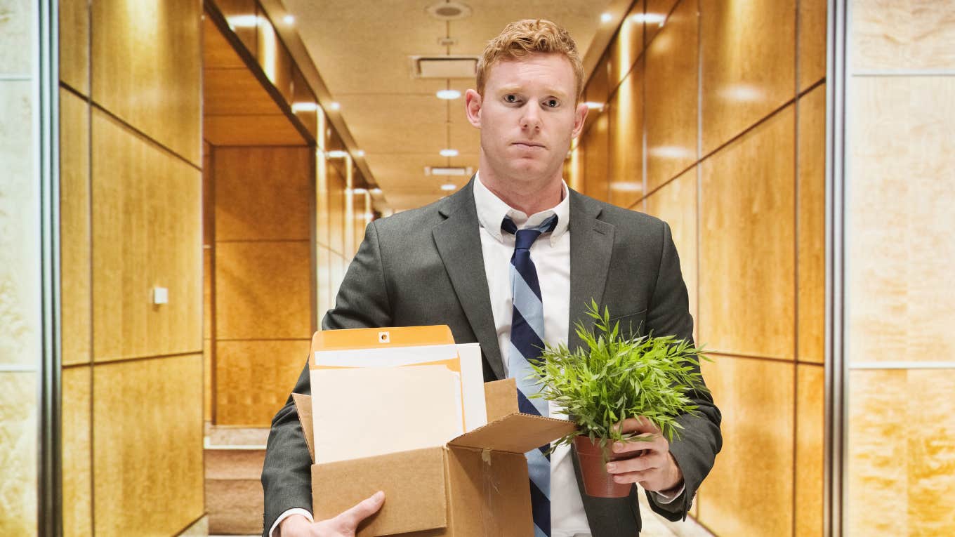 fired employee walking out of office with belongings