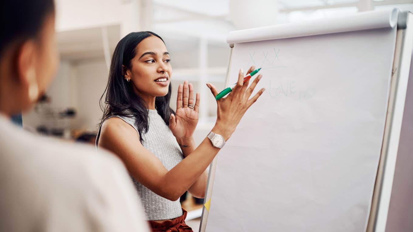 female employee giving presentation at work