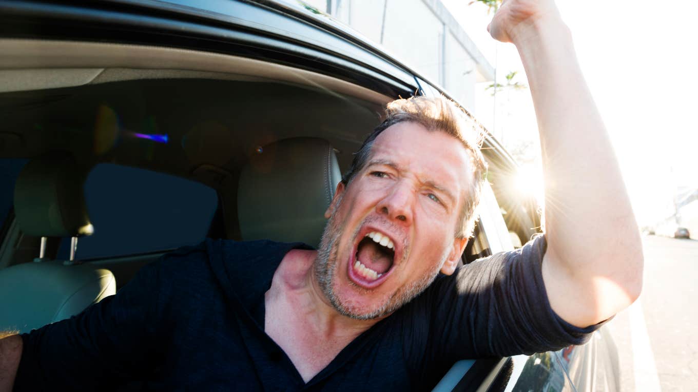 Tired man acting rude while sitting in traffic his way home. 