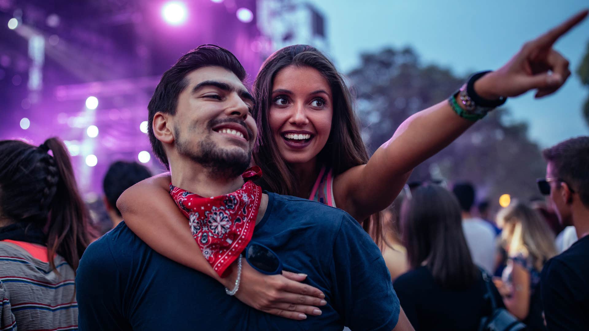 Couple smiling and hugging during a concert