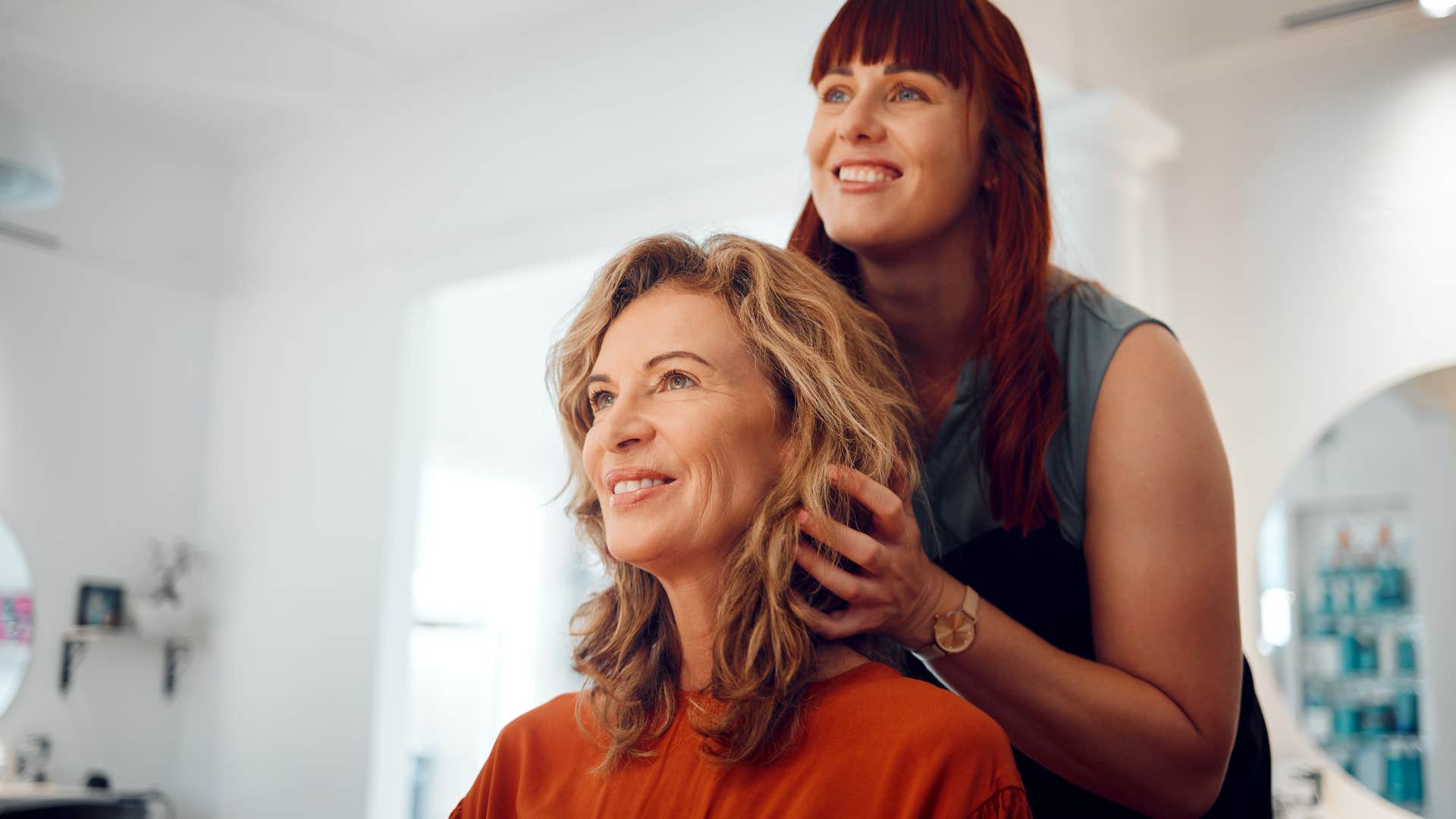 Woman sitting with her hairdresser