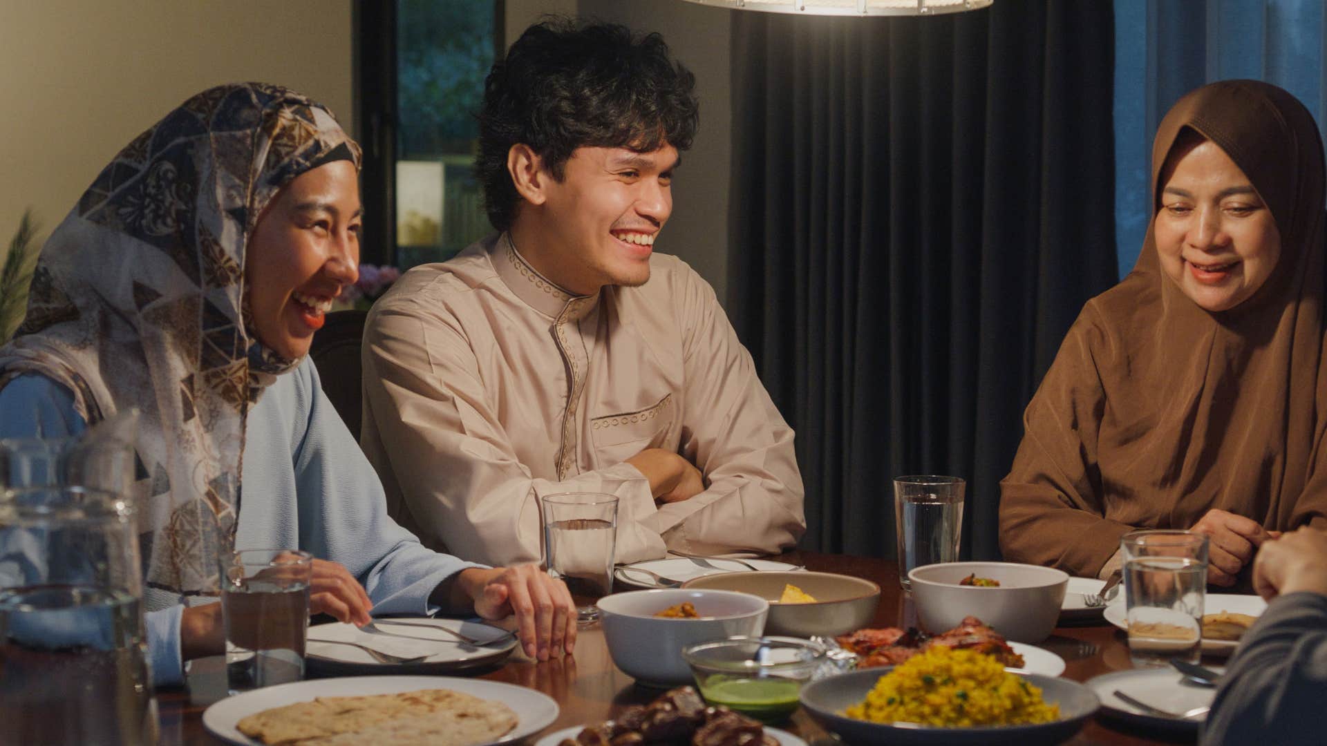 Family sitting at the dinner table celebrating a holiday together