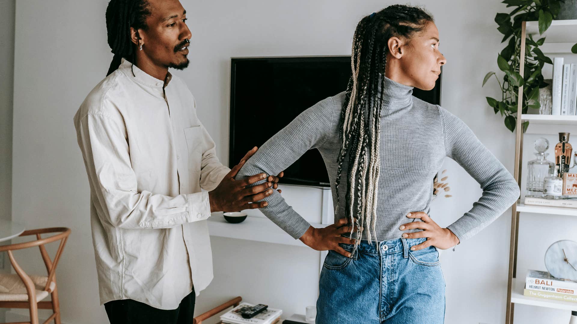 woman turning her head away from man while arguing