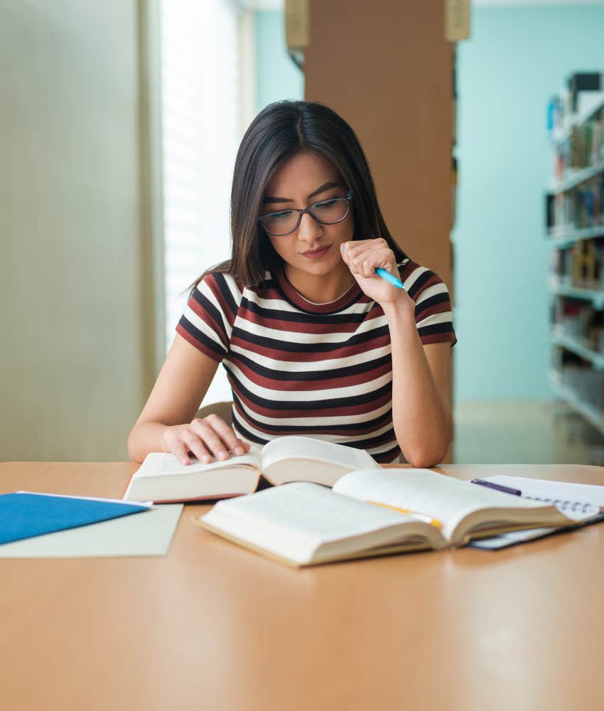 female college student studying in library