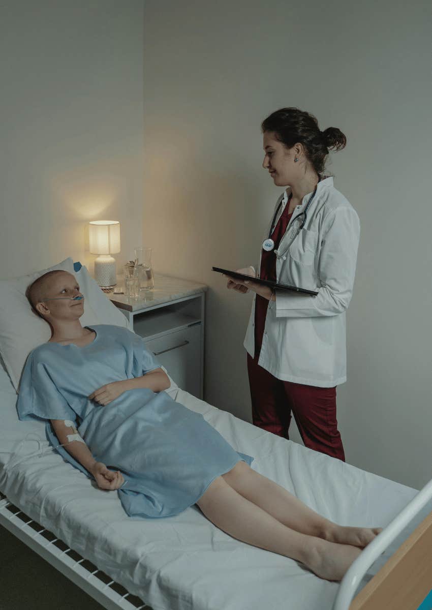 female doctor standing by patient's bedside