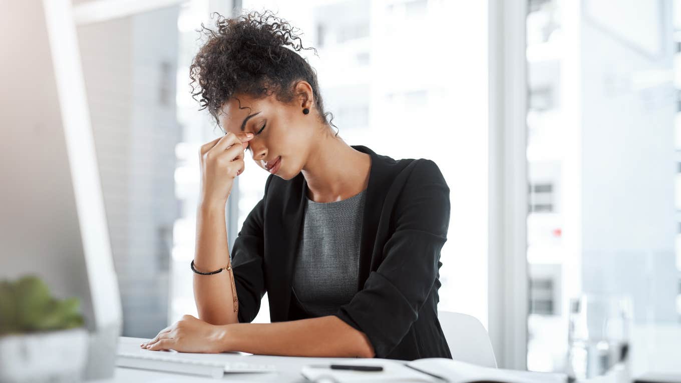 stressed business woman sitting at her desk