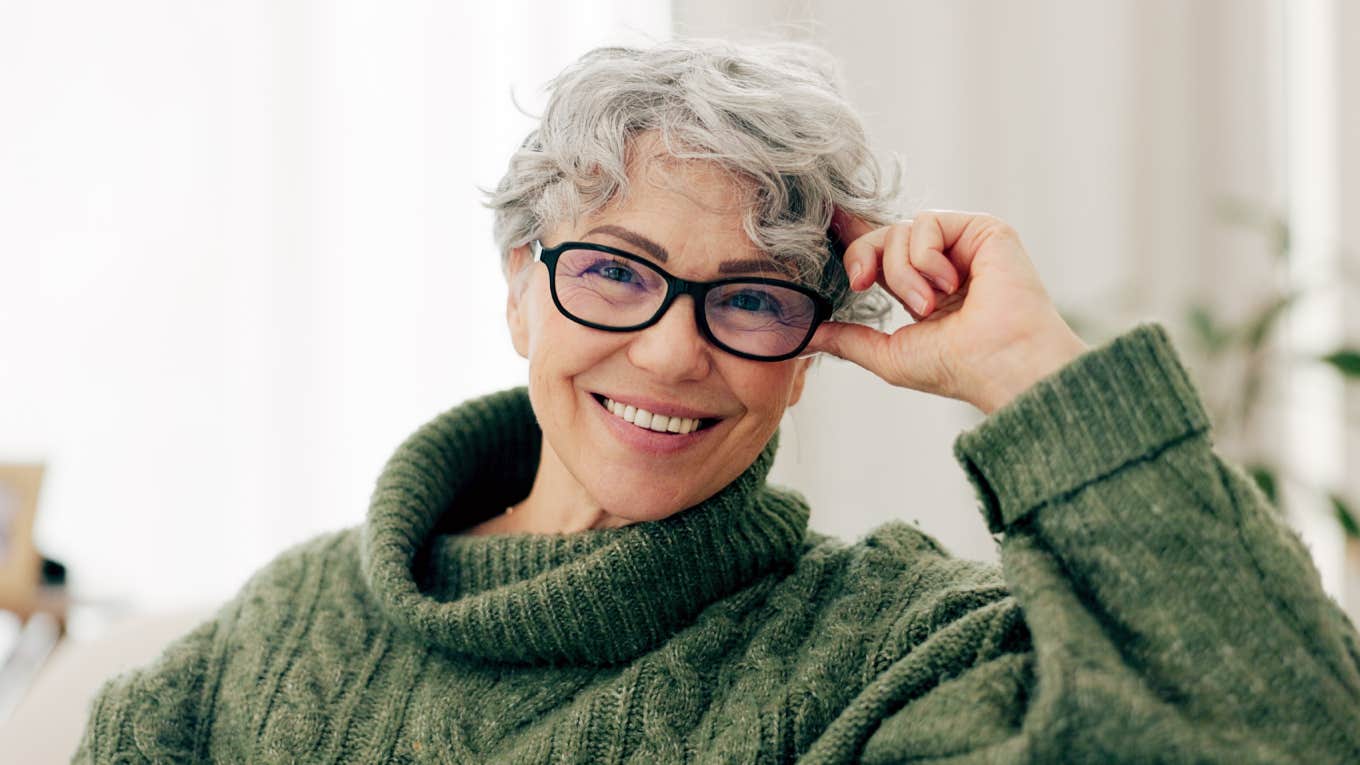 portrait of elderly woman smiling sitting on couch