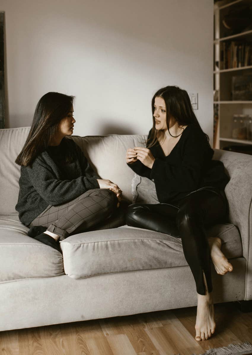 friends having a serious conversation on a couch