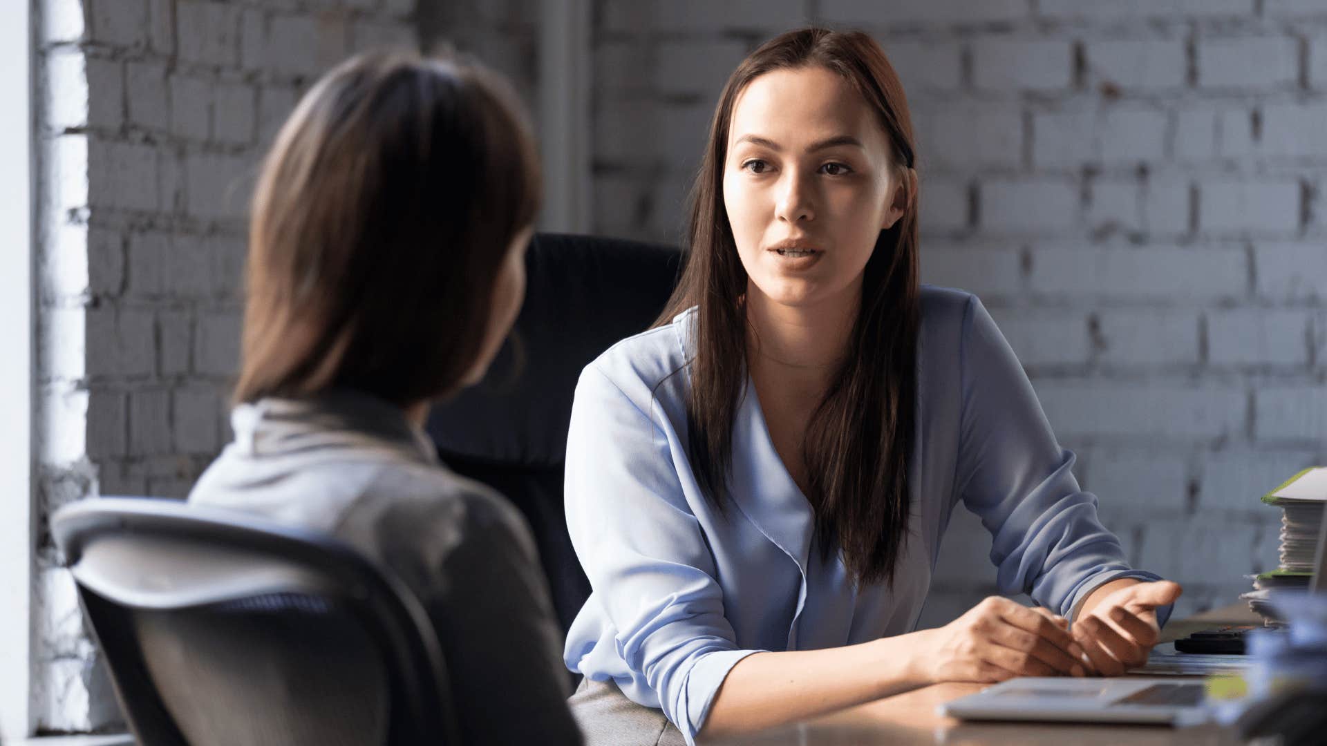 woman talking to coworker 