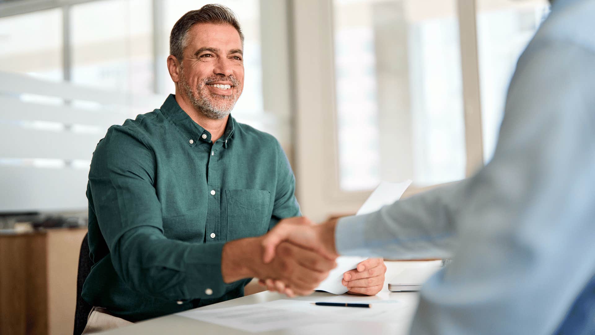 man shaking person's hand 