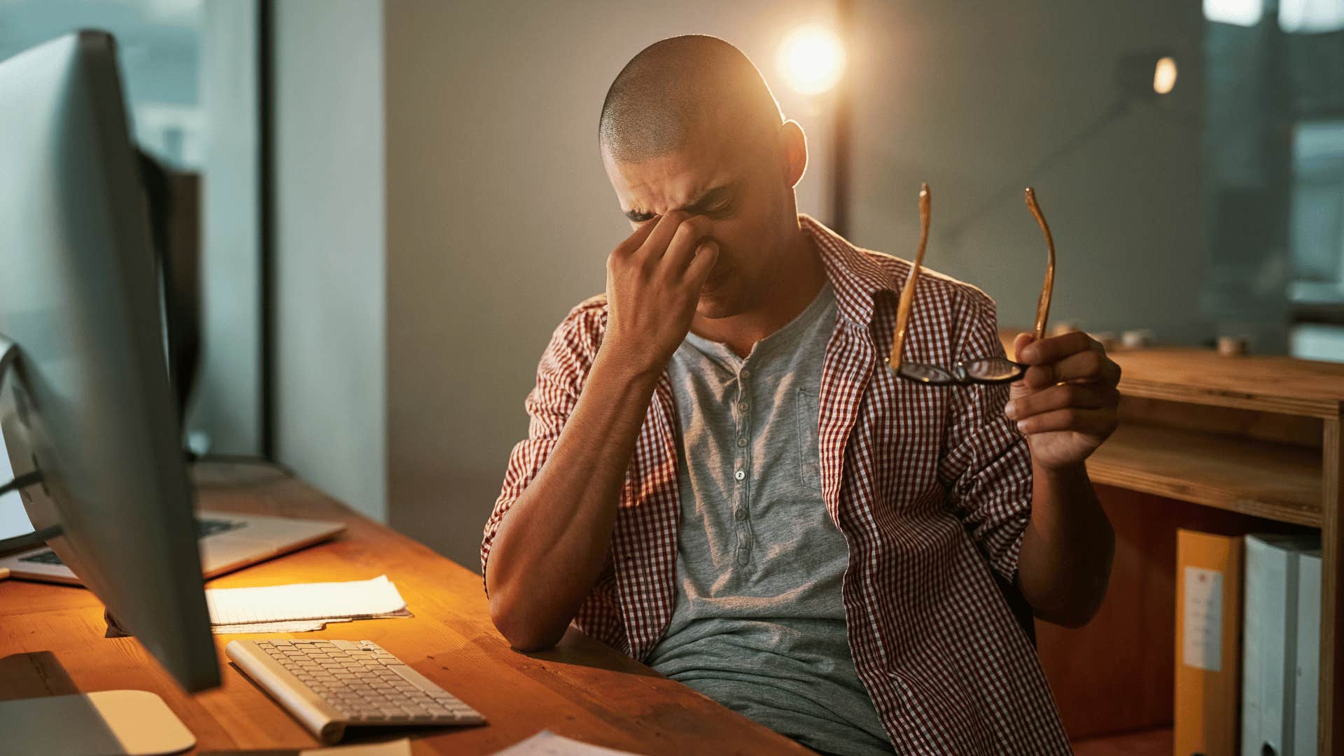 man working late looking frustrated 