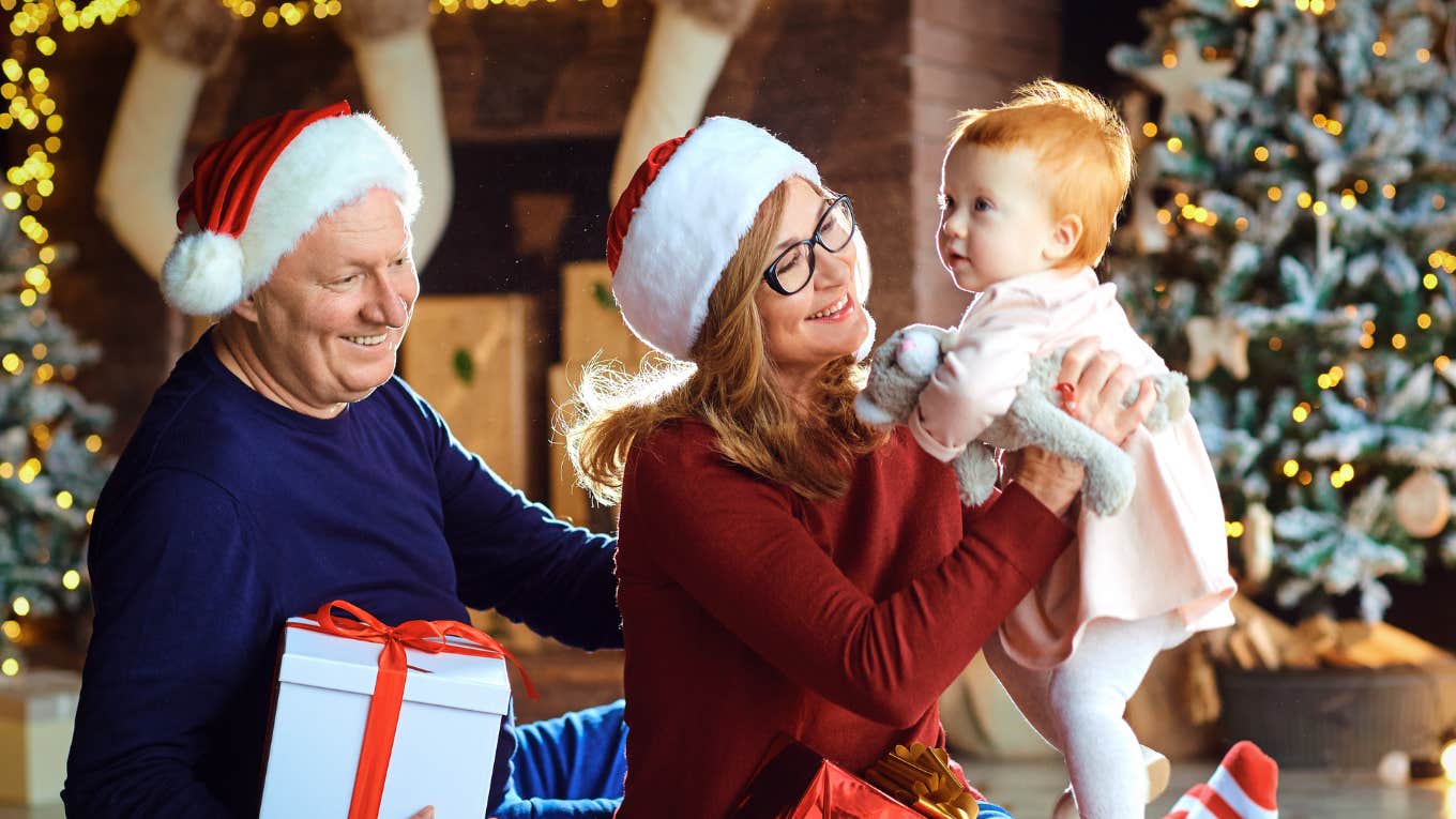 Grandparents sharing Christmas presents with grandchild