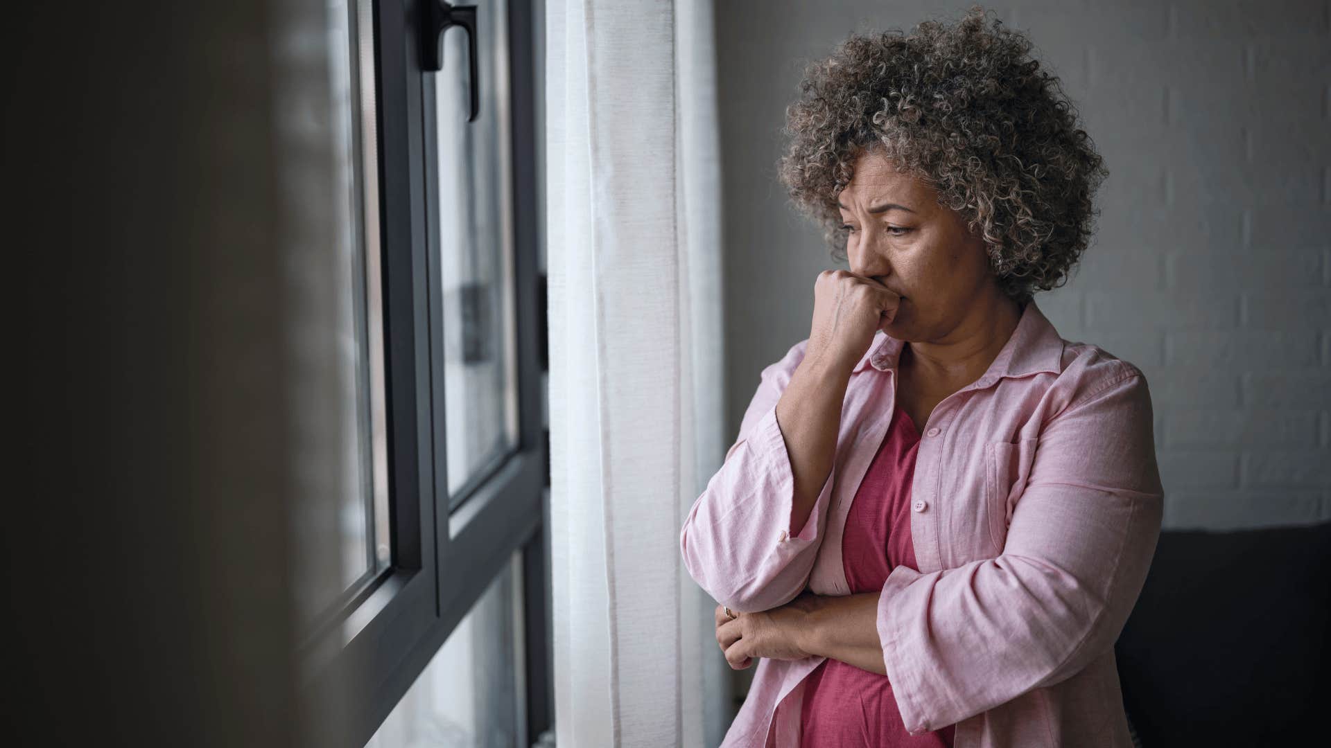 grandmother upset while facing window