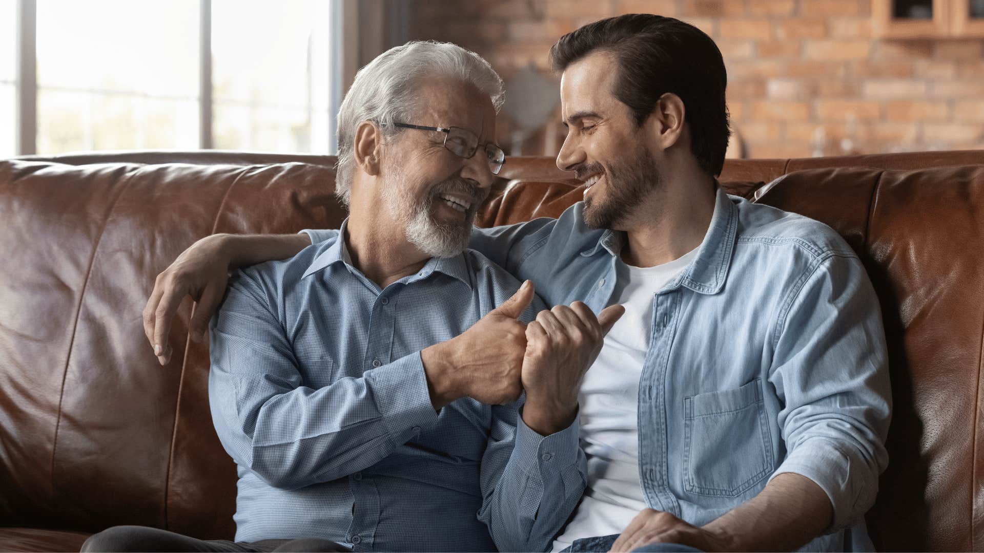 grandfather and grandson bonding while sitting on the couch