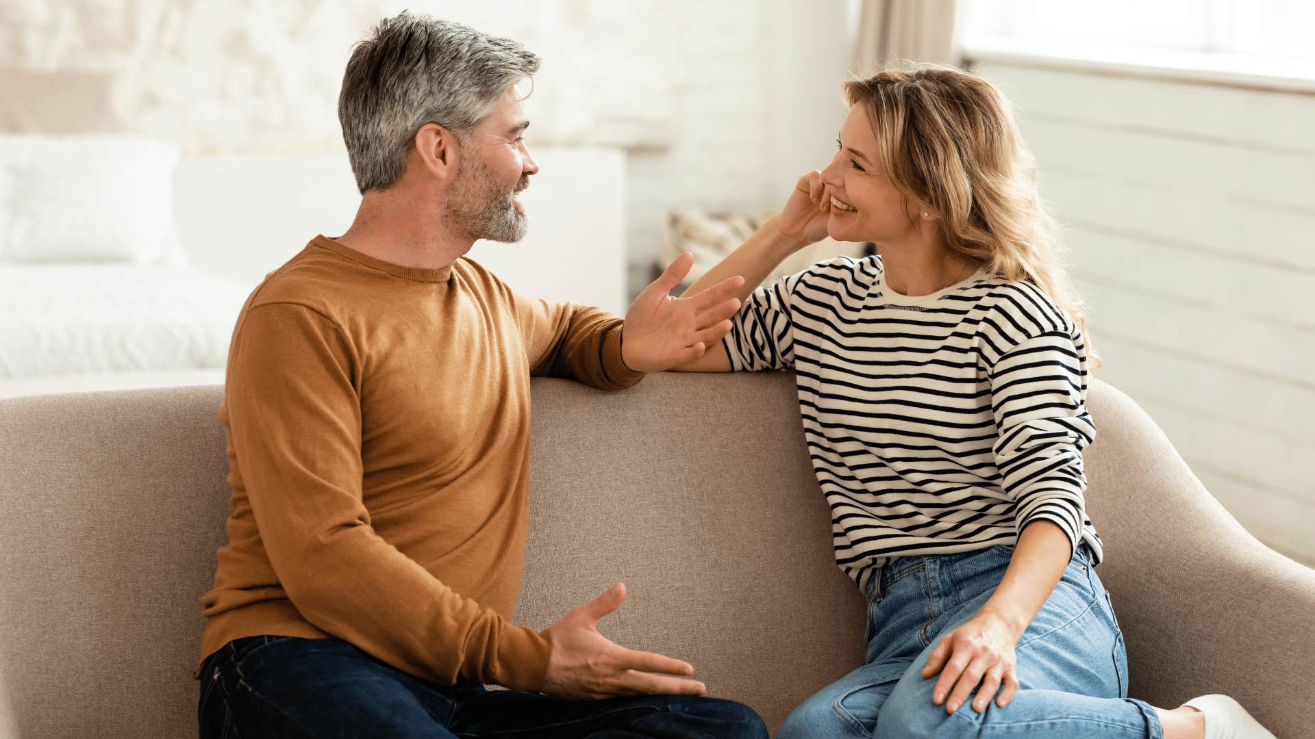 granddaughter and grandfather talking on the couch