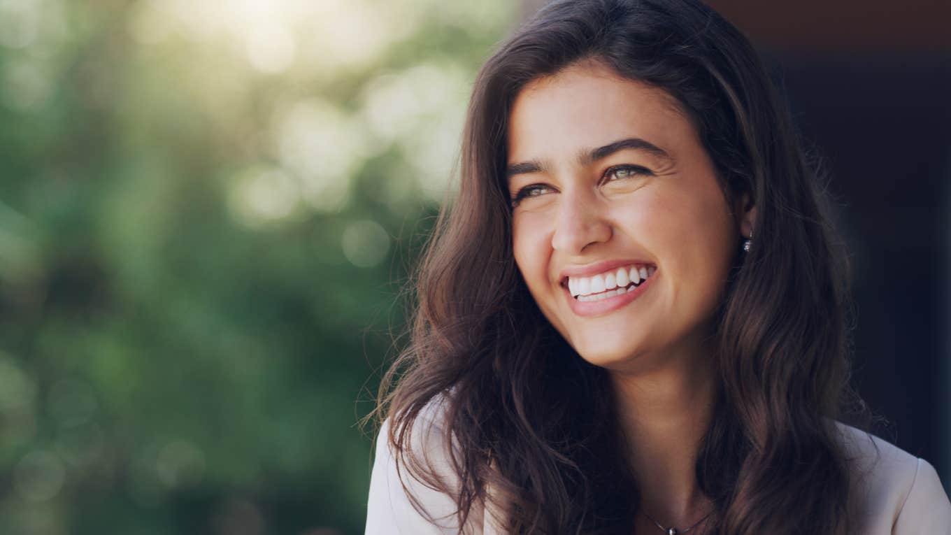 close up shot of happy woman smiling in nature