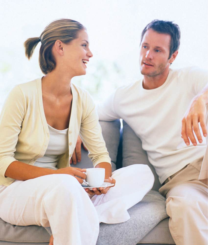 couple sitting on a couch talking