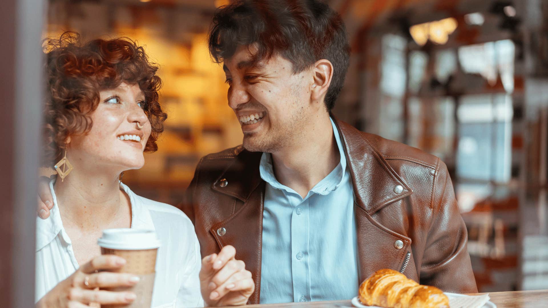 couple laughing at a coffee shop