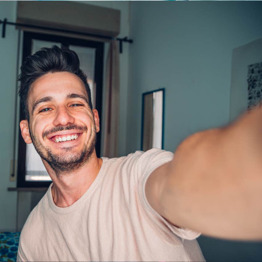 Handsome man taking a self portrait indoor at home