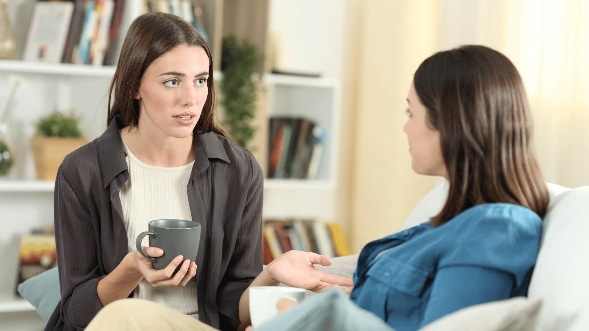 two women chatting while drinking coffee