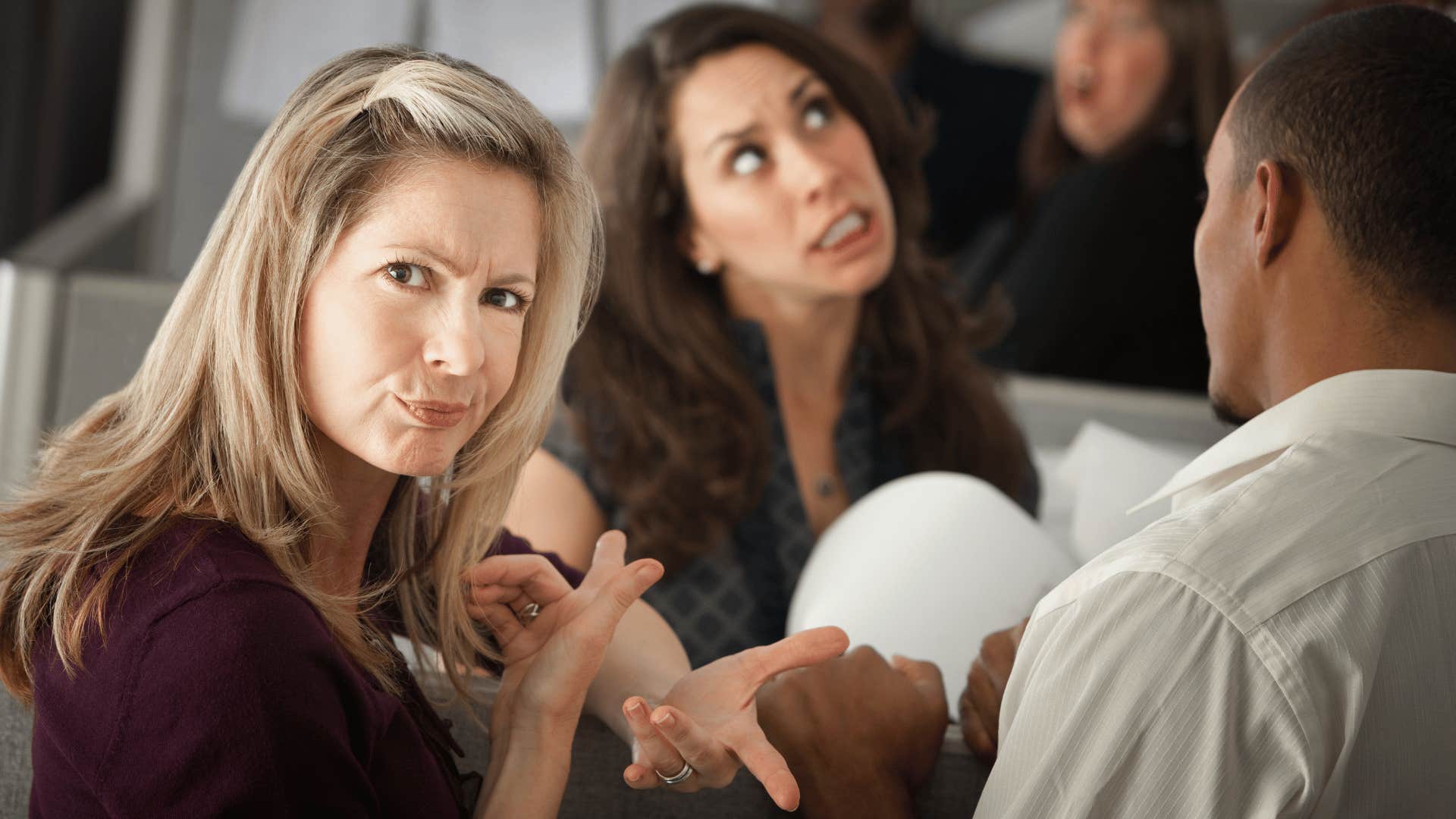 woman looking annoyed with other woman