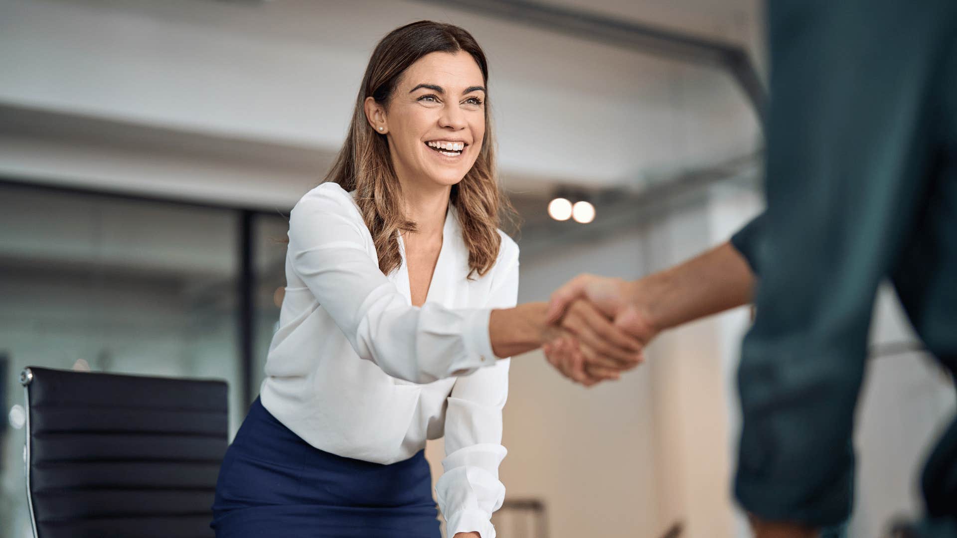 woman shaking man's hand