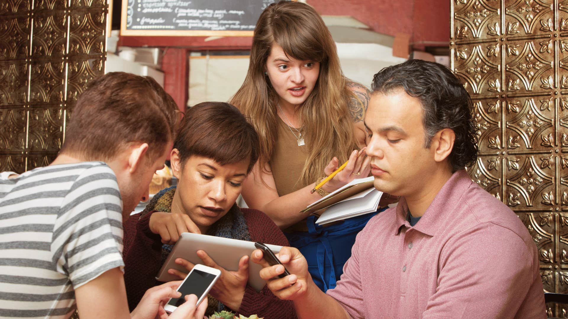 three men ignoring waitress