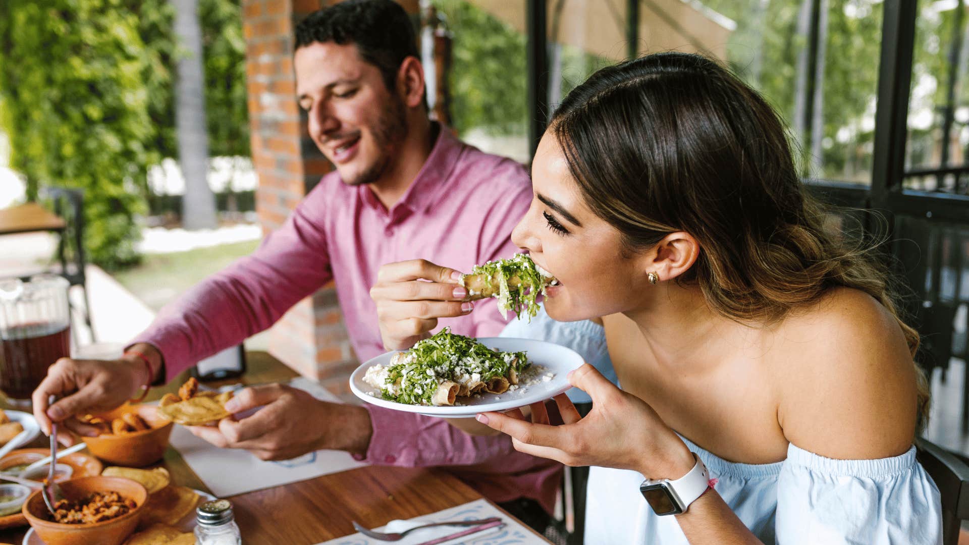 woman eating with man on date