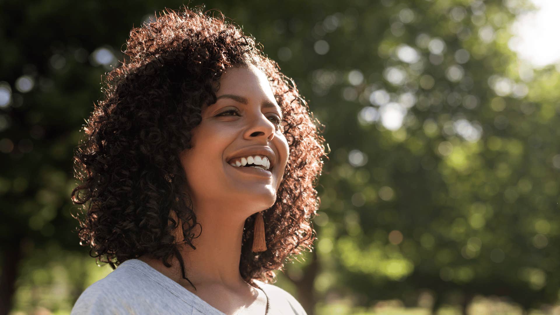 happy woman standing outside