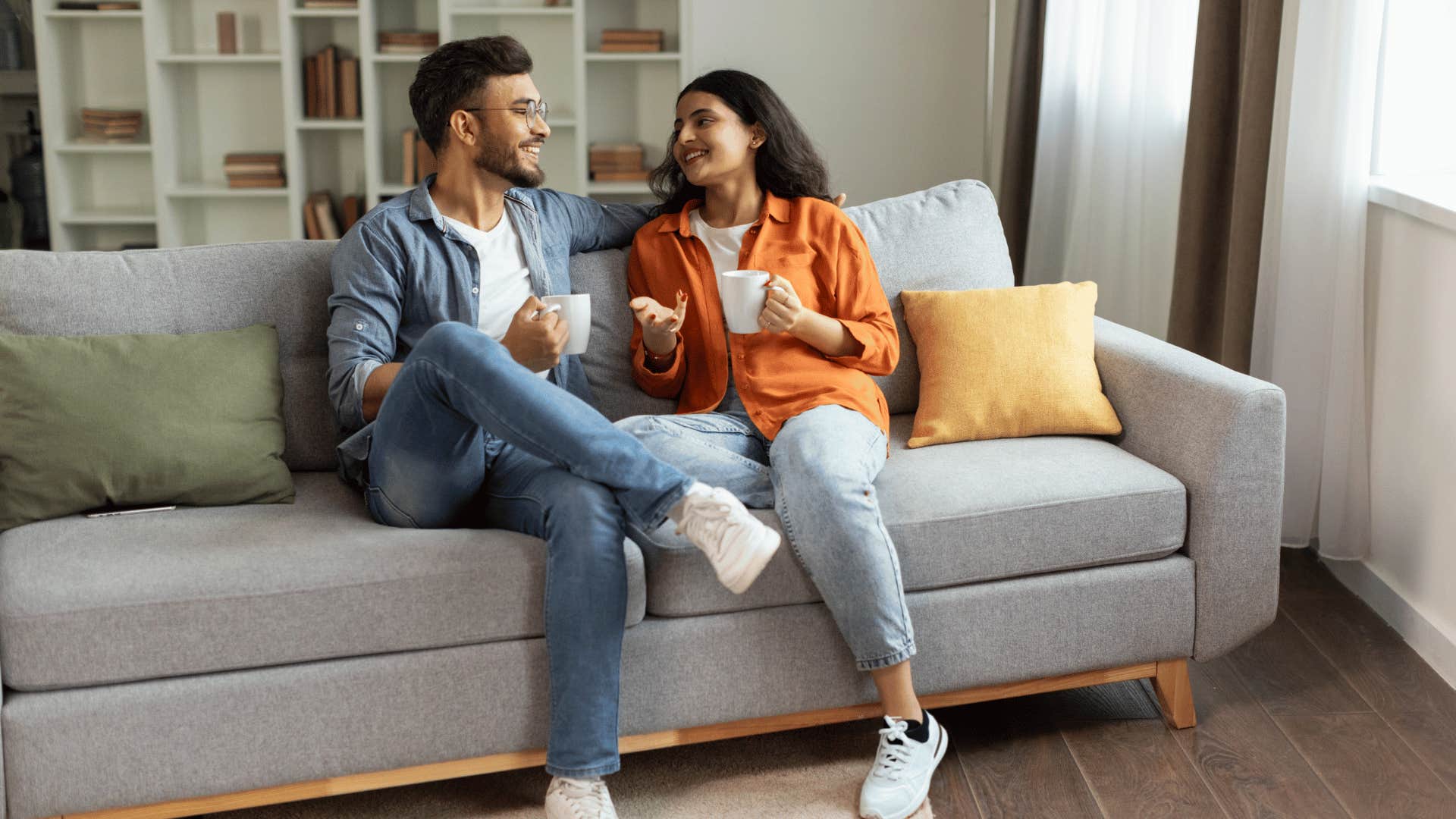 couple drinking coffee on a couch