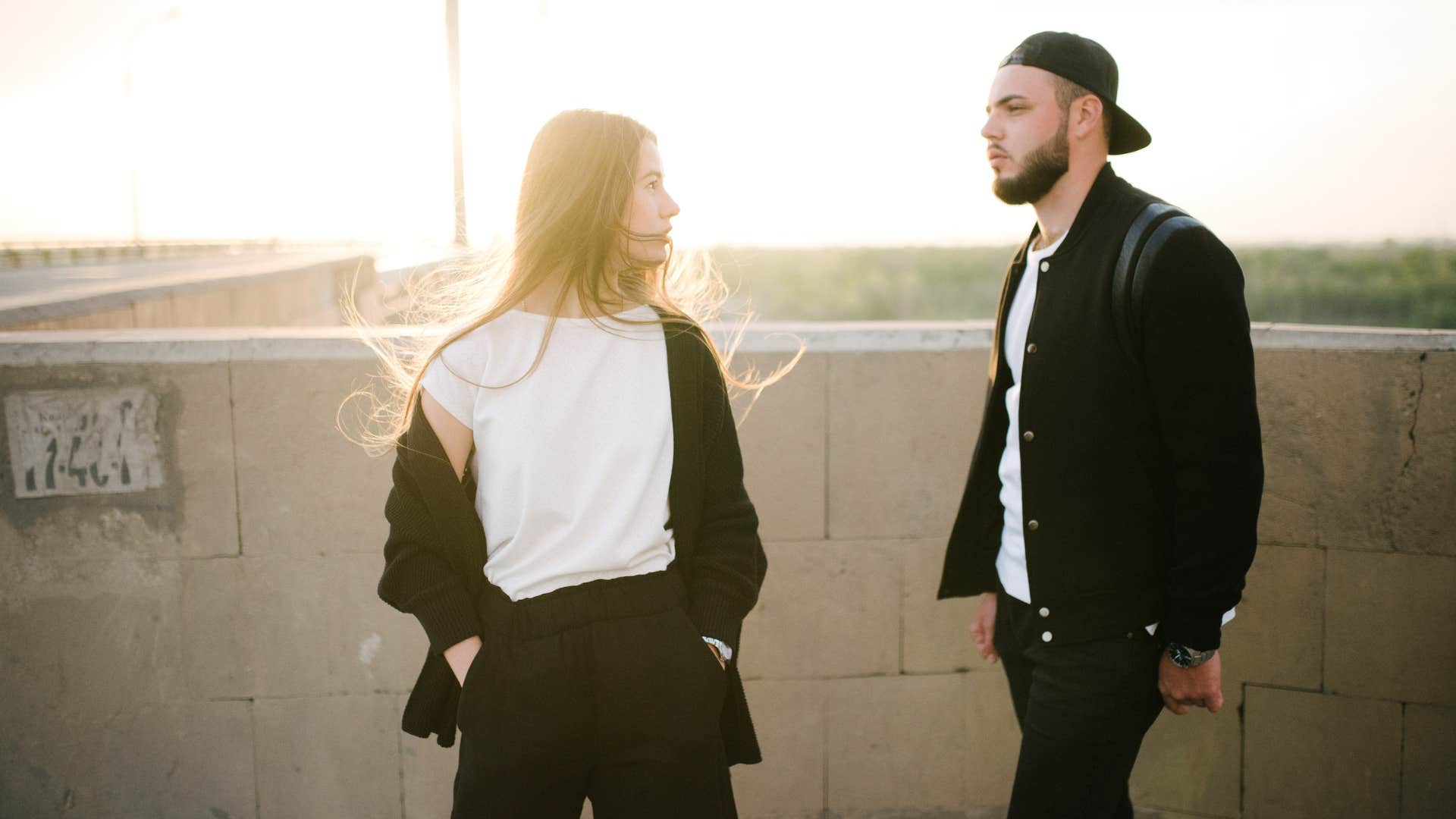 The guy and the girl walk on the bridge