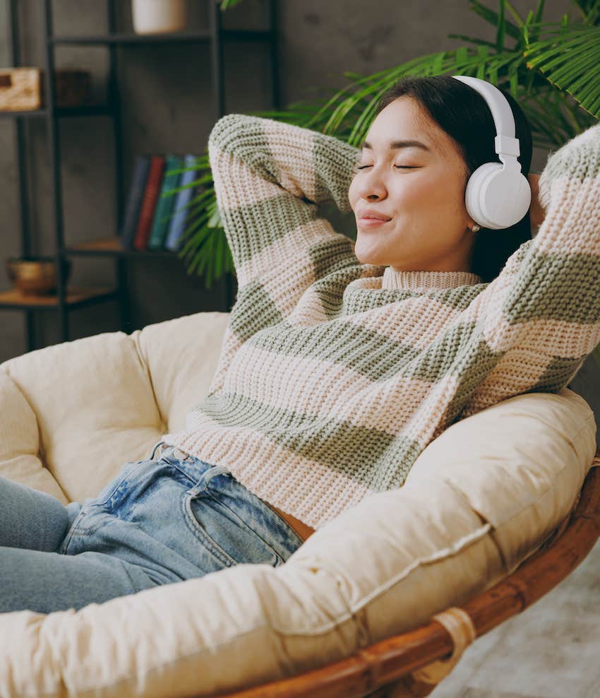 Woman with headphones listens to binaural beats