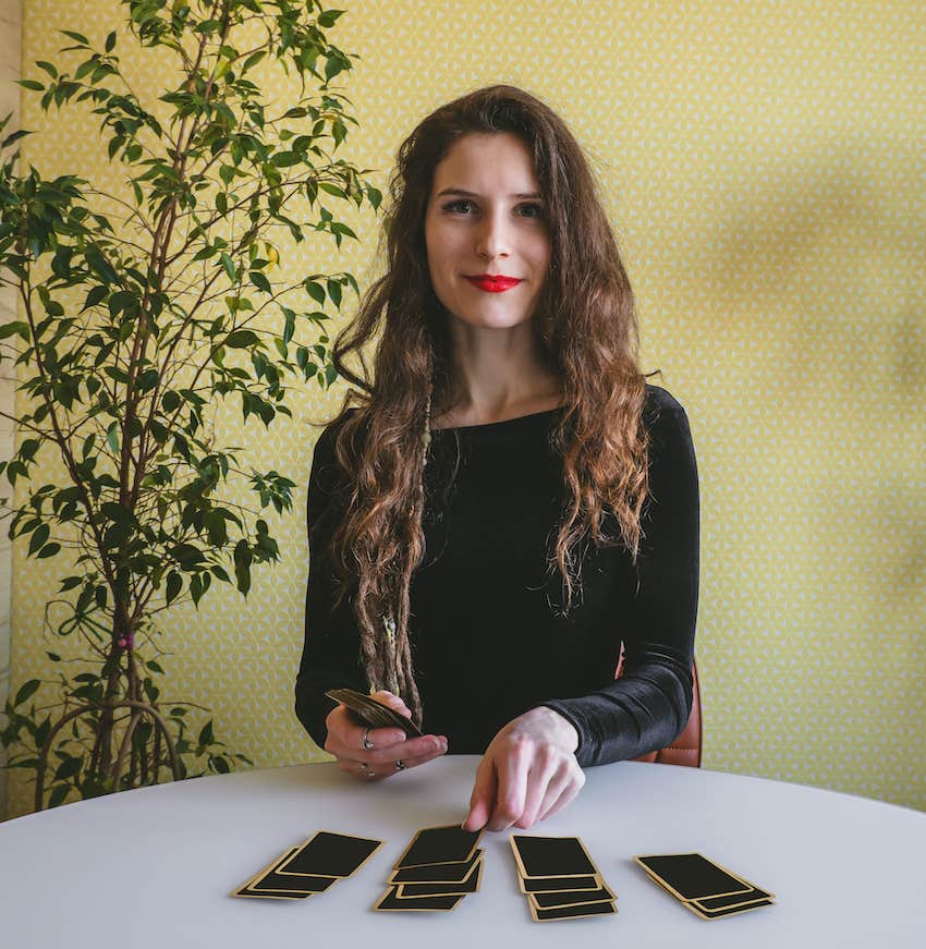 Woman places tarot cards on table