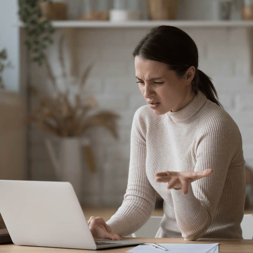 irritated woman staring at a laptop